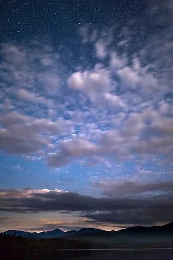 Starry Night Sky Over Mountain Horizon With Clouds