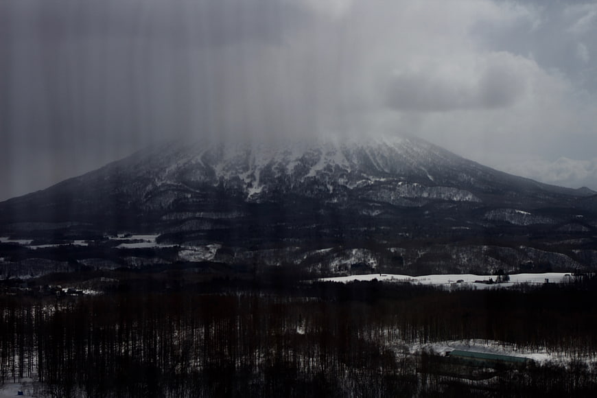 Snowy Mountain Landscape Through Rainy Window