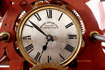Close-up of vintage red tower clock mechanism with gears