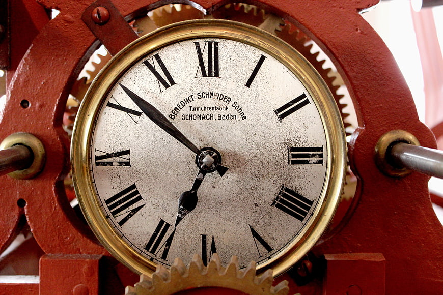 Close-up of vintage red tower clock mechanism with gears