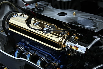Close-up of polished gold and blue classic car engine