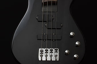 Close-up of Black Electric Bass Guitar Body and Bridge