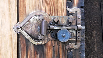Antique Rusty Iron Lock on Weathered Wooden Door