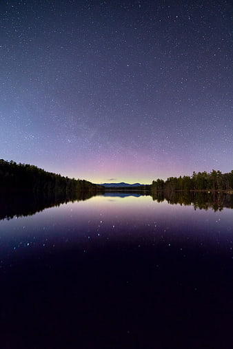 Starry Night Sky Reflection on Calm Lake with Forest