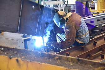 Industrial Welder Working on Steel Structure in Factory