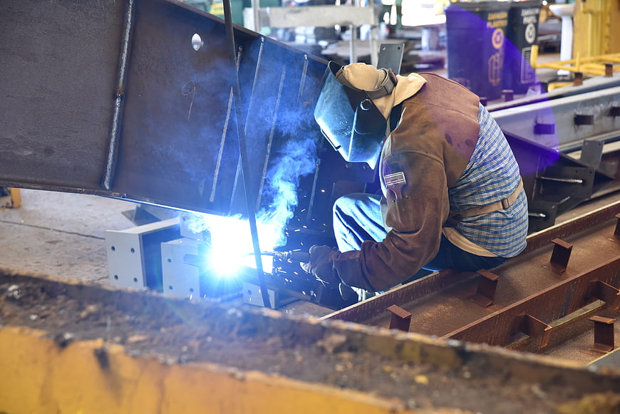 Industrial Welder Working on Steel Structure in Factory