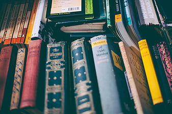 Close-up of vintage books on a shelf with shallow depth of field