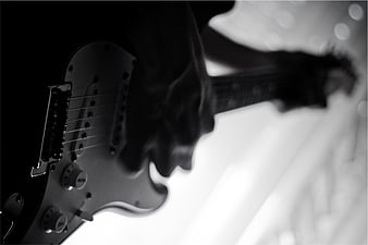 Black and white close-up of electric guitar being played