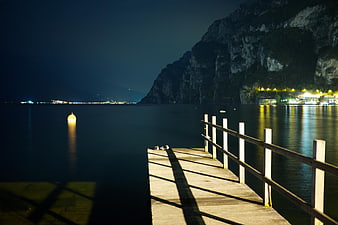 Wooden Pier at Night with Mountain and Lake Reflections