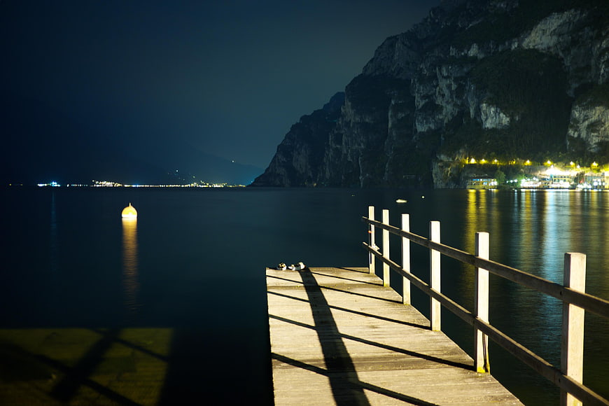 Wooden Pier at Night with Mountain and Lake Reflections