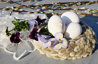 White Easter Eggs in Knitted Nest with Pansies and Willow Catkins