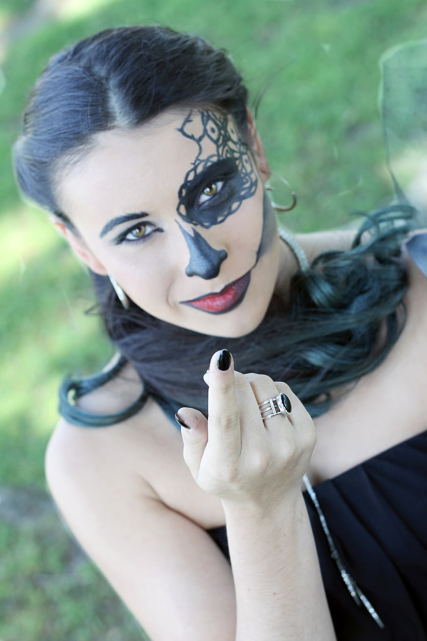 Woman with Gothic Halloween Face Paint and Black Makeup