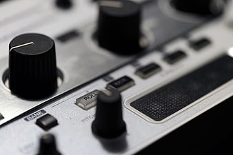Close-up of DJ mixer knobs and controls