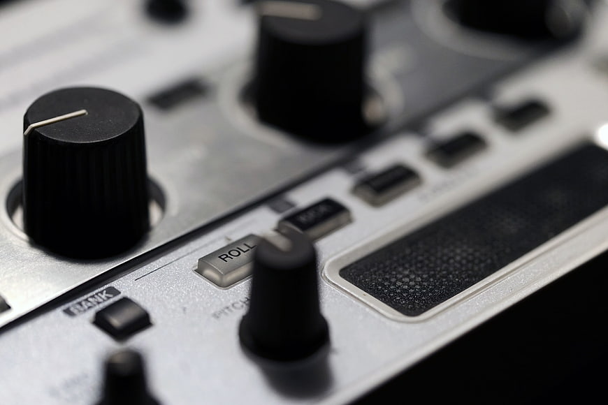 Close-up of DJ mixer knobs and controls