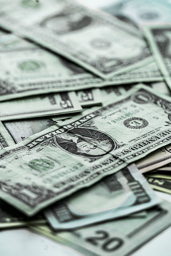 Close-up of scattered US dollar bills and cash currency