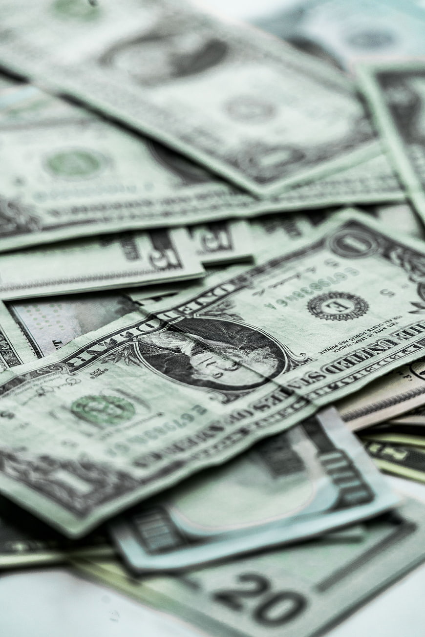 Close-up of scattered US dollar bills and cash currency
