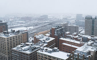 Aerial View of Snowy Cityscape with Highways and Buildings