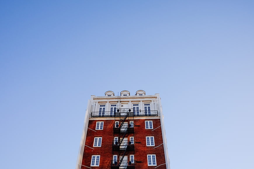 Low angle view of red brick building against blue sky