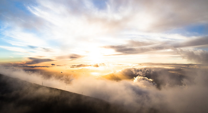 Sunrise Over Mountain Ridge With Sea of Fog and Clouds