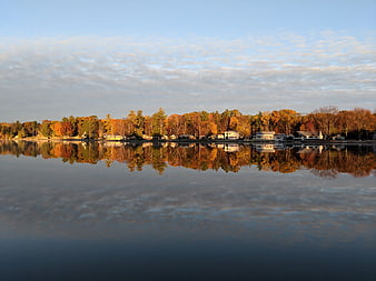 Serene Autumn Lake Reflection with Colorful Trees and Houses