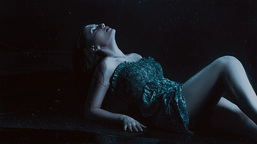 Woman in Wet Lace Dress Lying in Rain