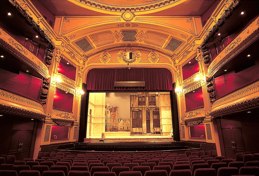 Ornate Opera House Interior with Stage and Red Seats
