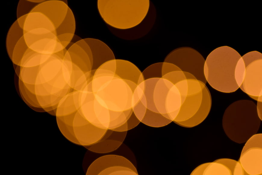 Abstract golden bokeh lights on black background