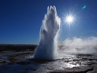 Strokkur Geyser Eruption in Iceland with Sun Flare