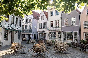Historic European Town Square With Colorful Buildings And Outdoor Cafe Seating