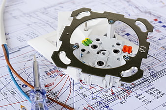 Electrical Outlet Component On Blueprint With Screwdriver