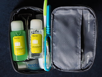 Open Travel Toiletry Bag With Grooming Essentials And Toothbrush