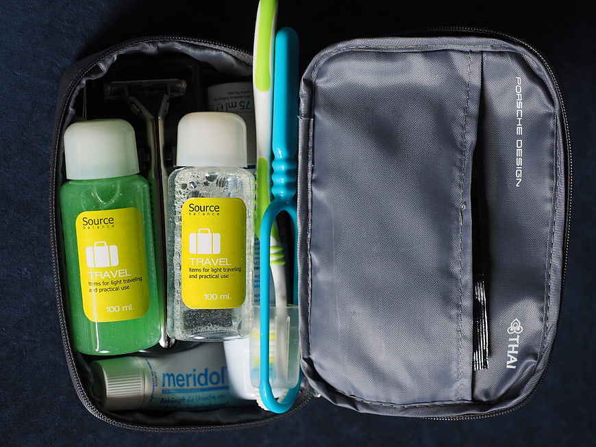 Open Travel Toiletry Bag With Grooming Essentials And Toothbrush