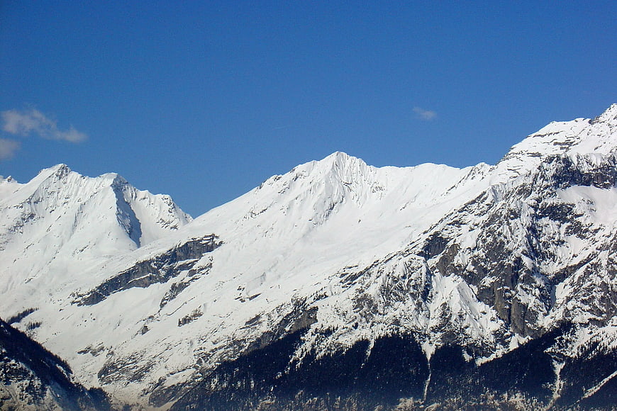 Snow-Capped Alpine Mountain Peaks Under Blue Sky