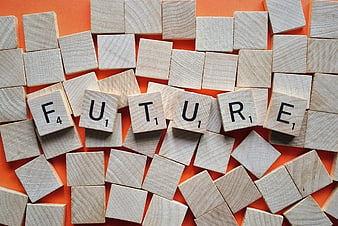 Wooden Scrabble Tiles Spelling Future on Orange Background