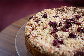 Close-up of cranberry crumble cake on wooden board