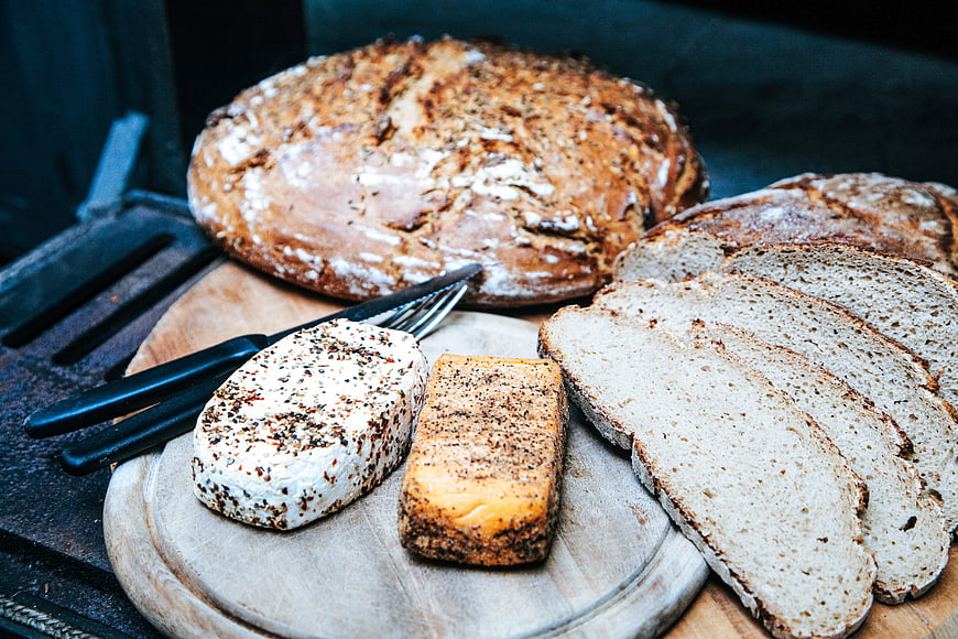 Rustic Artisan Bread Loaf with Slices and Seasoned Butter