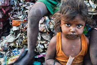 Portrait of young girl in slum holding food