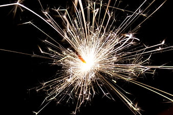 Bright Sparkler Bursting Against Black Night Background