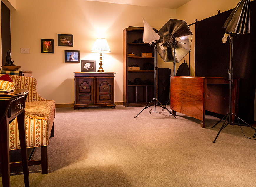 Home Photography Studio Setup With Umbrella Lights And Furniture