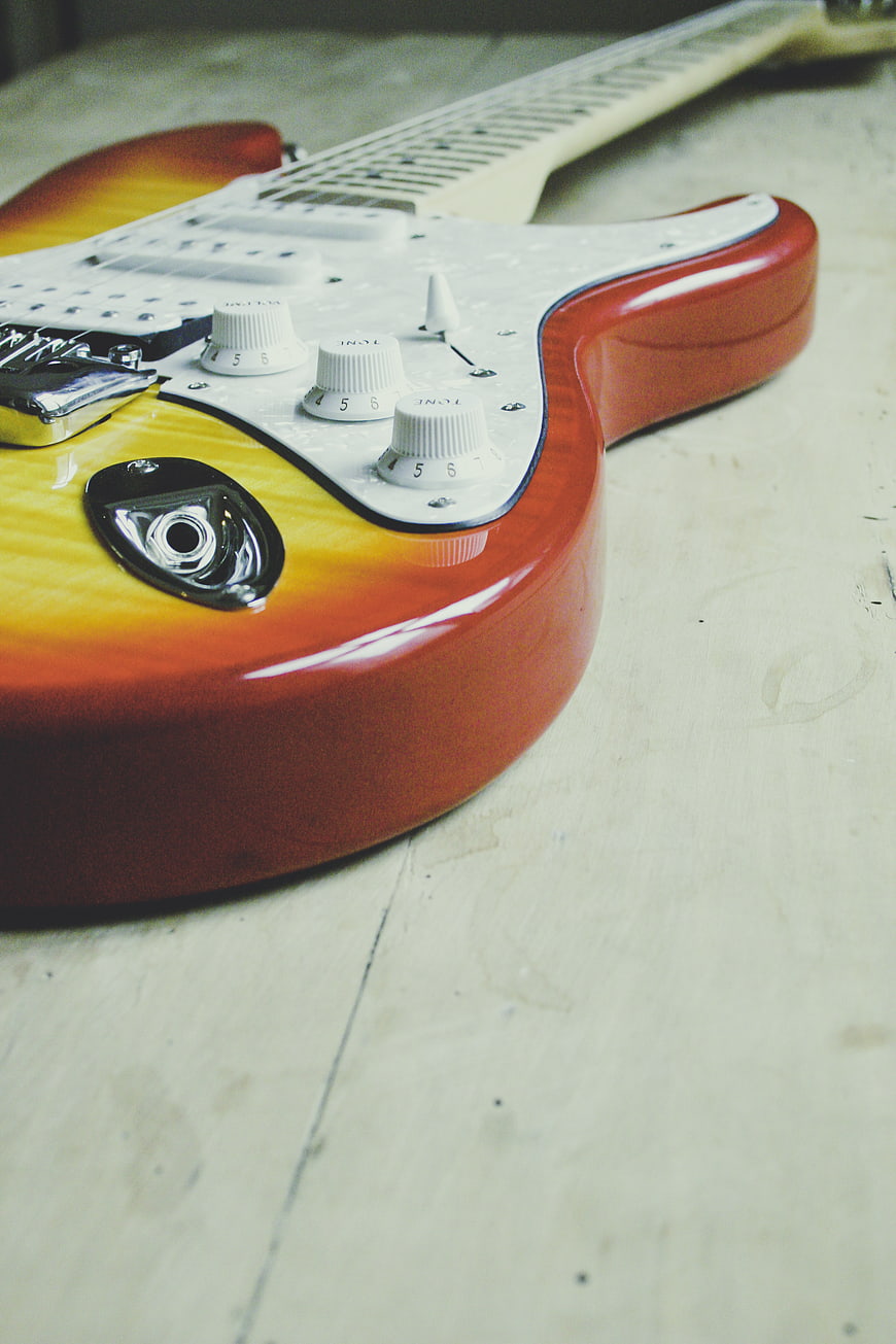 Close-up of Vintage Sunburst Electric Guitar on Wooden Floor