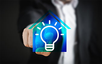 Businessman touching smart home light bulb icon on screen