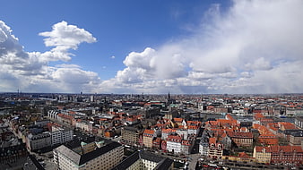 Aerial View of Copenhagen Cityscape with Red Roofs and Blue Sky