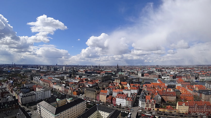 Aerial View of Copenhagen Cityscape with Red Roofs and Blue Sky