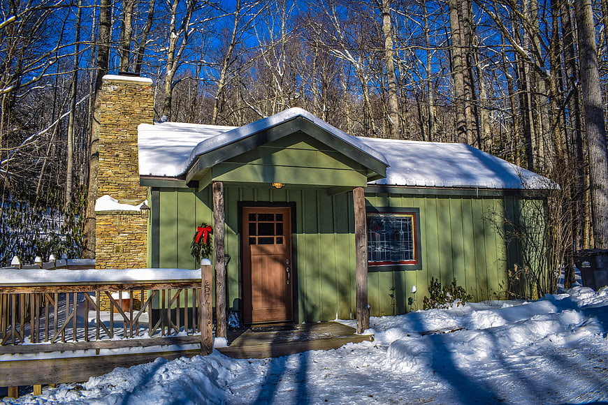 Cozy Green Cabin in Snowy Winter Forest