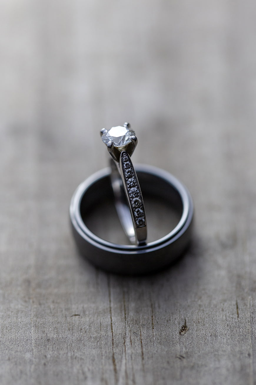 Diamond engagement ring and wedding band on rustic wood