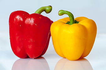 Fresh Red and Yellow Bell Peppers on White Background
