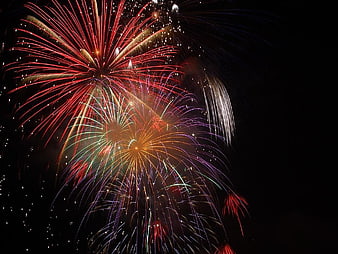 Colorful Fireworks Display Against Dark Night Sky