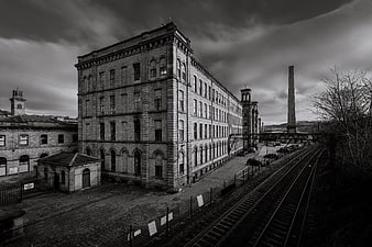 Black and White Photo of Historic Industrial Mill and Railway Tracks