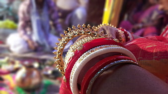 Close-up of Indian Bride's Red and White Bangles and Gold Jewelry