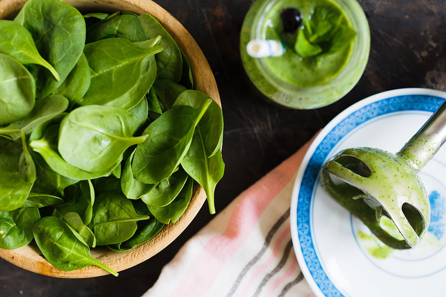 Fresh spinach smoothie ingredients and immersion blender top view